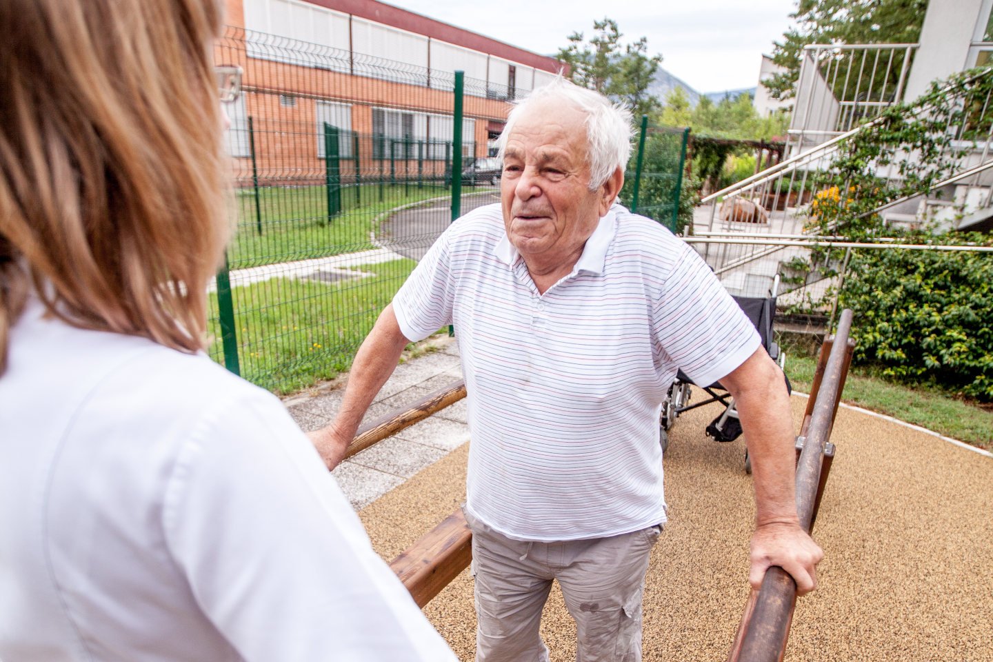 Disabled senior man exercising outdoors in retirement community.