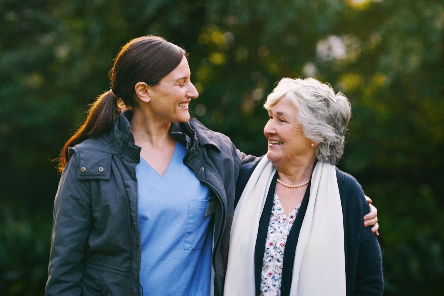 Shot of a senior woman and young nurse going for a walk in a garden