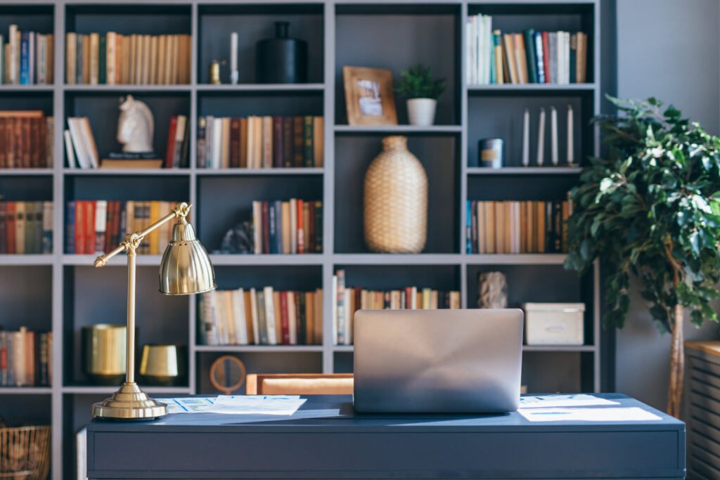 Table with laptop in home office interior